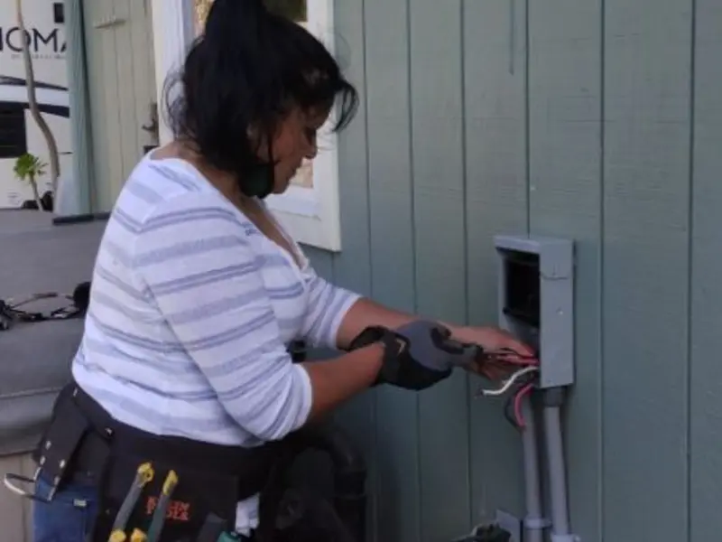 Licensed electrician wiring an exterior subpanel in Almont